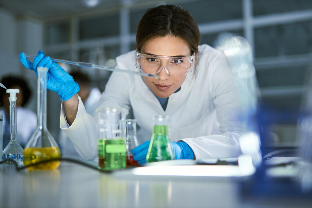 Female chemist working on medical research in laboratory.